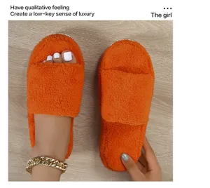 Detailed close-up showing the soft plush texture of these vibrant orange fuzzy slippers
