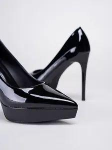 Detailed macro view of elegant glossy black patent leather platform stiletto pumps