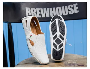 Detailed view of white men's breathable loafers with textured finish and rubber sole.