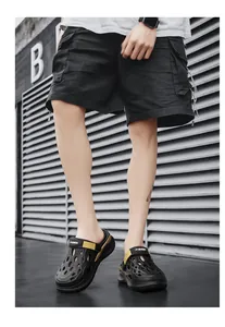 Fashionable black and yellow men's breathable clogs for casual summer outdoor activities.