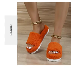 Detail of bright orange fuzzy towel slides with thick white platform soles