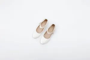 Elegant white patent leather Mary Jane flat shoes with decorative ankle straps