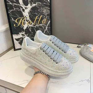Detailed view of women's full rhinestone platform sneakers with thick grey laces