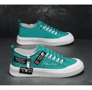 Detailed shot of teal canvas sneakers with thick white soles and decorative labels