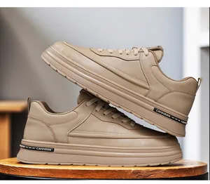 Detail of beige leather casual sneakers with lace-up design and textured thick sole.