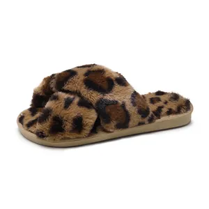 Macro view showing the soft leopard print faux fur texture of the crisscross slipper.