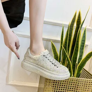 Side view of sparkling rhinestone chunky platform sneakers for women.