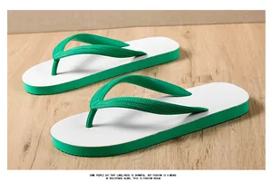 Detailed close-up of trendy green and white rubber flip-flops on natural wood surface.