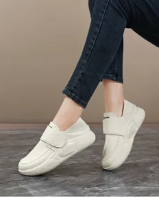Close-up detail of cream leather anti-slip work shoes for women with velcro strap