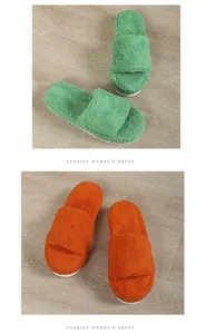 Detailed view showing the soft texture of green and orange fuzzy towel slide slippers.