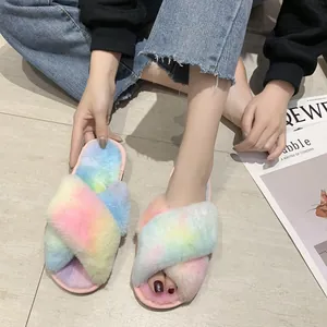 Detail view of colorful rainbow tie-dye faux fur slippers with cross straps