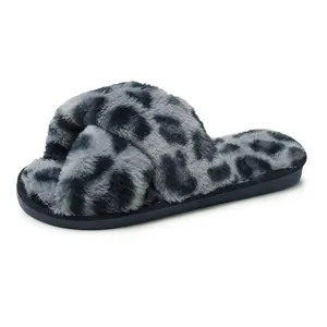 Close-up detail of soft grey leopard print plush slippers featuring a stylish cross-strap design