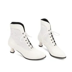 Detail view of white Victorian lace ankle boots with kitten heels and lace-up front