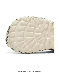 Macro detail showing the durable lugged rubber outsole texture on winter outdoor cotton slippers