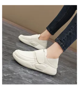 Side view detail showing cream non-slip leather work shoes with convenient hook-and-loop strap