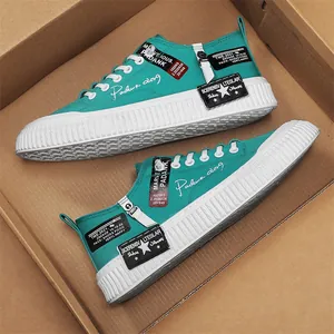 Teal men's canvas sneakers with chunky white platform soles and graphic prints