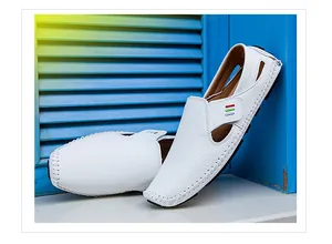 Detail view of white leather driving loafers with decorative side stripes and perforated design.