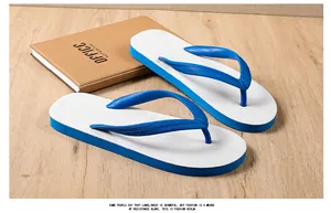 Detailed view of casual men's non-slip blue and white flip-flops on a wooden surface