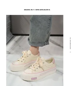 Close-up detail of cream platform sneakers featuring pink accents and woven design