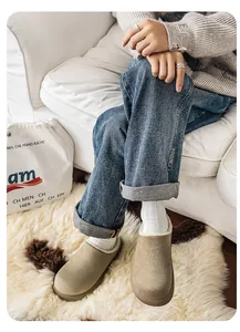 Premium khaki suede slip-on clogs with fleece lining worn in a cozy home setting