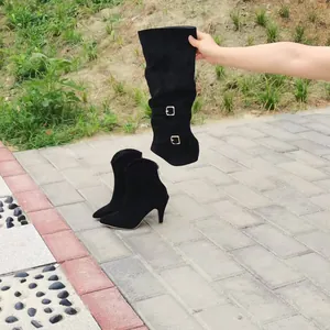 Detail showing the height of black pointed toe stiletto over-the-knee boots.