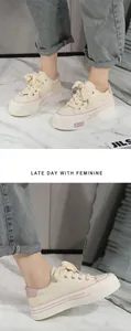 Detailed macro view of women's thick-soled platform canvas sneakers in cream with pink accents