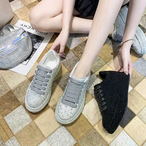 Detail view of luxurious rhinestone-encrusted platform sneakers in silver and black