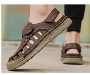 Detailed side view of men's brown leather hollow sandals worn for outdoor walking