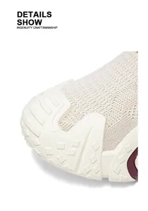 Macro view of breathable fly-knit sneaker showing textured rubber sole and knit details