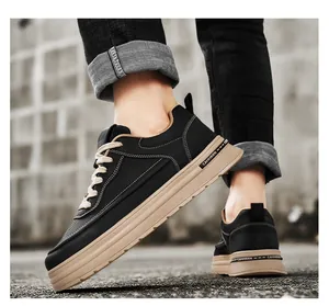 Close-up detail of men's black leather casual sneakers with thick tan platform soles.
