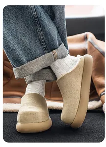Detailed close-up of beige suede-like cotton mules worn with white socks and denim jeans