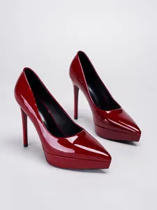 Detailed view of elegant red patent leather stiletto pumps with platform and pointed toe
