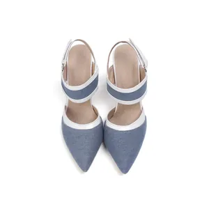 Vista superior de tacones de aguja en denim azul con punta fina y ribete blanco.