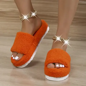 Close-up detail of vibrant orange fuzzy platform slippers featuring thick white soles.