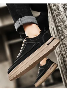 Detailed view of men's black workwear casual sneakers featuring thick tan soles