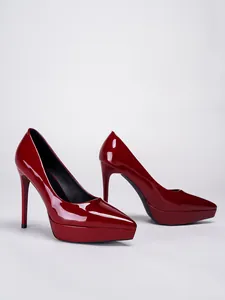 Elegant red patent leather platform pumps with pointed toes and high stiletto heels