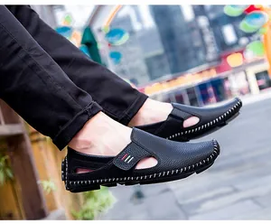 Side view of men's black slip-on loafers with breathable hollow design and hand stitching