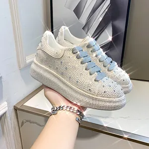 Detailed view of sparkling rhinestone platform sneakers featuring stylish blue-grey laces