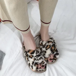 Detailed view of women's stylish faux fur leopard print slippers with cross-band design
