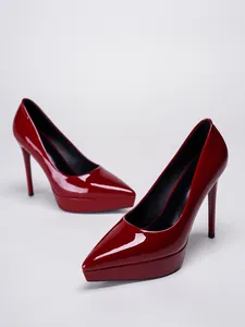 Detailed close-up view of elegant glossy red patent leather platform stiletto high heels.