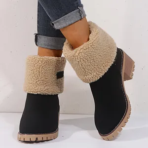 Detail of women's black winter boots with thick beige faux fur cuffs and treaded soles.