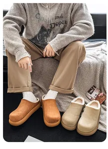 Cozy men's camel faux suede clogs with warm white faux fur lining on a lifestyle sofa