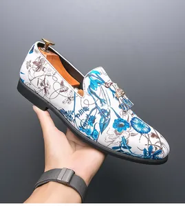 Detail view of men's Chinese style floral print loafer with tassel and metal hardware