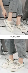Close-up view of women's beige platform canvas sneakers with stylish blue stripe accents