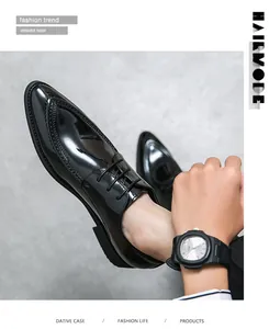 Close-up detail of shiny black pointed-toe formal dress shoes for men with lace-up style.