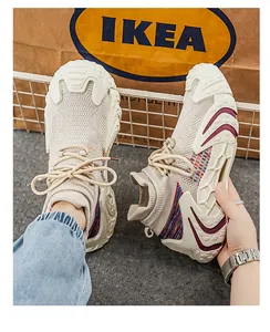Detailed texture of beige flying woven sock sneakers with thick anti-slip soles for outdoor use.