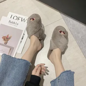 Detailed shot of comfortable grey faux fur cross-strap slippers for indoor wear