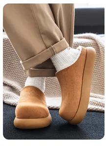 Detail view of suede camel clogs with warm fleece lining and thick sole for autumn.