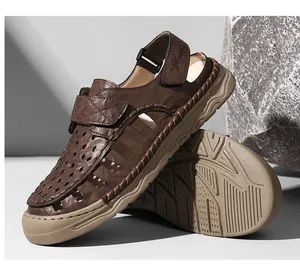 Close-up detail of brown breathable men's leather sandals with a stylish hollow-out design