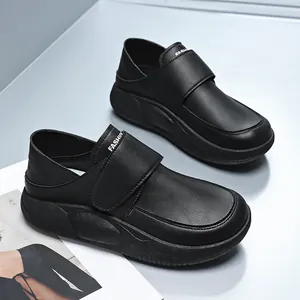 All-black non-slip women's work shoes with Velcro strap and thick leather-like sole.